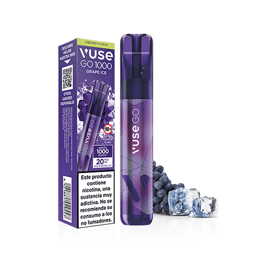 Un vapeador desechable Vuse Go 1000 - Uva Ice de Vuse, en envase morado, se muestra con cubitos de hielo y uvas. La caja muestra advertencias sanitarias españolas sobre la nicotina y sus propiedades adictivas.